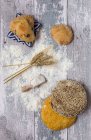 Rural bread with flour on wooden table — Stock Photo