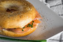 Crop bagel with smoked salmon and cream cheese — Stock Photo
