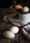 Still life of chicken eggs on wooden table — Stock Photo