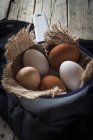 Five eggs on sacking in metal scoop — Stock Photo