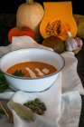 Bowl of pumpkin soup with vegetables — Stock Photo