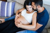 Happy parents embracing their not yet born child, awaiting for moment in mothers belly. — Stock Photo