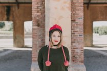 Girl in knitted hat smilling at camera — Stock Photo