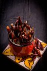 Spicy red chili peppers in cup — Stock Photo