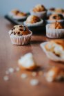 Close up view of homemade muffins with chocolate in wrapper — Stock Photo