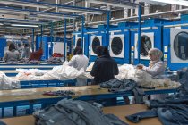 TANGIER, MOROCCO- April 18, 2016: rear view of workers at clothing manufactures — стоковое фото