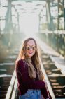 Girl in sunglasses on bridge. — Stock Photo
