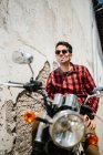 Man sitting on bike and smoking — Stock Photo