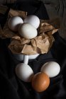 Still life of chicken eggs in mug on rural fabric — Stock Photo
