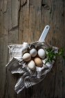 Directly above view of chicken eggs in pan on wooden table — Stock Photo