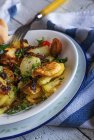 Crop fried potatoes with parsley and cherry tomato — Stock Photo