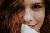 Close up portrait of ginger girl  with freckles looking at camera — Stock Photo