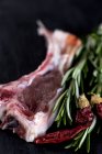 Raw lamb ribs with herbs and dried chilli — Stock Photo
