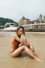 Donna in posa sulla spiaggia in acqua — Foto stock