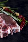 Raw lamb ribs with herbs and dried chilli — Stock Photo