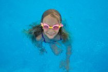 From above view of kd in goggles in swimming pool — Stock Photo