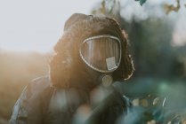 Portrait of man with gas mask on his face standing in field — Stock Photo