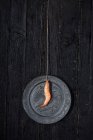 Shrimp hanging on string over silver plate — Stock Photo