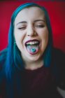 Girl showing candy on her tongue. — Stock Photo