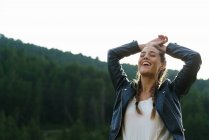 Cheerful blonde girl laughing in nature — Stock Photo