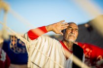 Retrato del hombre árabe mayor mirando la cámara mostrando el gesto de saludo. - foto de stock