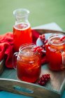 Red currant beverage in jars — Stock Photo