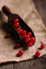 Red currant in wooden scoop — Stock Photo