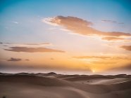 Desert landscape over dawn sky — Stock Photo