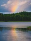 Rainbow reflection in lake — Stock Photo