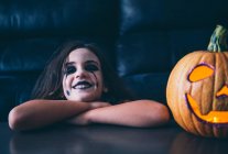 Malicious girl with pumpkin halloween — Stock Photo
