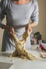 Female hands braking risen dough — Stock Photo