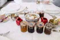 Close up view of different jams and sugar served on a table. — Stock Photo