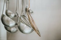 Aluminum made ladles hanging at kitchen. — Stock Photo
