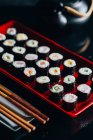 Sushi set on red plate — Stock Photo