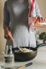 Emale hands adding water to flour — Stock Photo