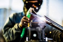 Man with obscure face doing welding — Stock Photo