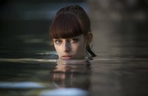 Girl looking at camera from water — Stock Photo