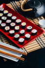 Served sushi set on red plate — Stock Photo