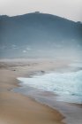 View to misty sandy coast and sea — Stock Photo