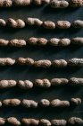 Shelled peanuts pattern on dark surface — Stock Photo