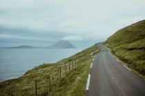 Landscape of rural road on seaside slope of hill — Stock Photo