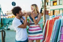 Portrait of cheerful young people and looking at each other with smile and gesturing at street scene — Stock Photo