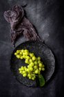 Directly above view of fresh grapes on dark table. — Stock Photo