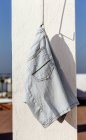 Blue jeans short hanging on terrace in sunlight — Stock Photo