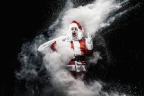 Astonished Santa Claus in mist of snow splashes — Stock Photo