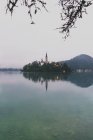 Scenic view of mountain lake with towers on opposite shore — Stock Photo
