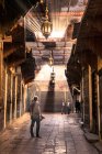 Back view of man standing in sun flares on street scene in Morocco. — Stock Photo