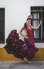 Flamenco dancer wearing typical costume posing over building exterior — Stock Photo