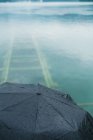 Высокоугловой зонт над озером с железными дорогами под бирюзовой водой — стоковое фото