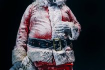 Mid section of Santa Claus covered with snow — Stock Photo